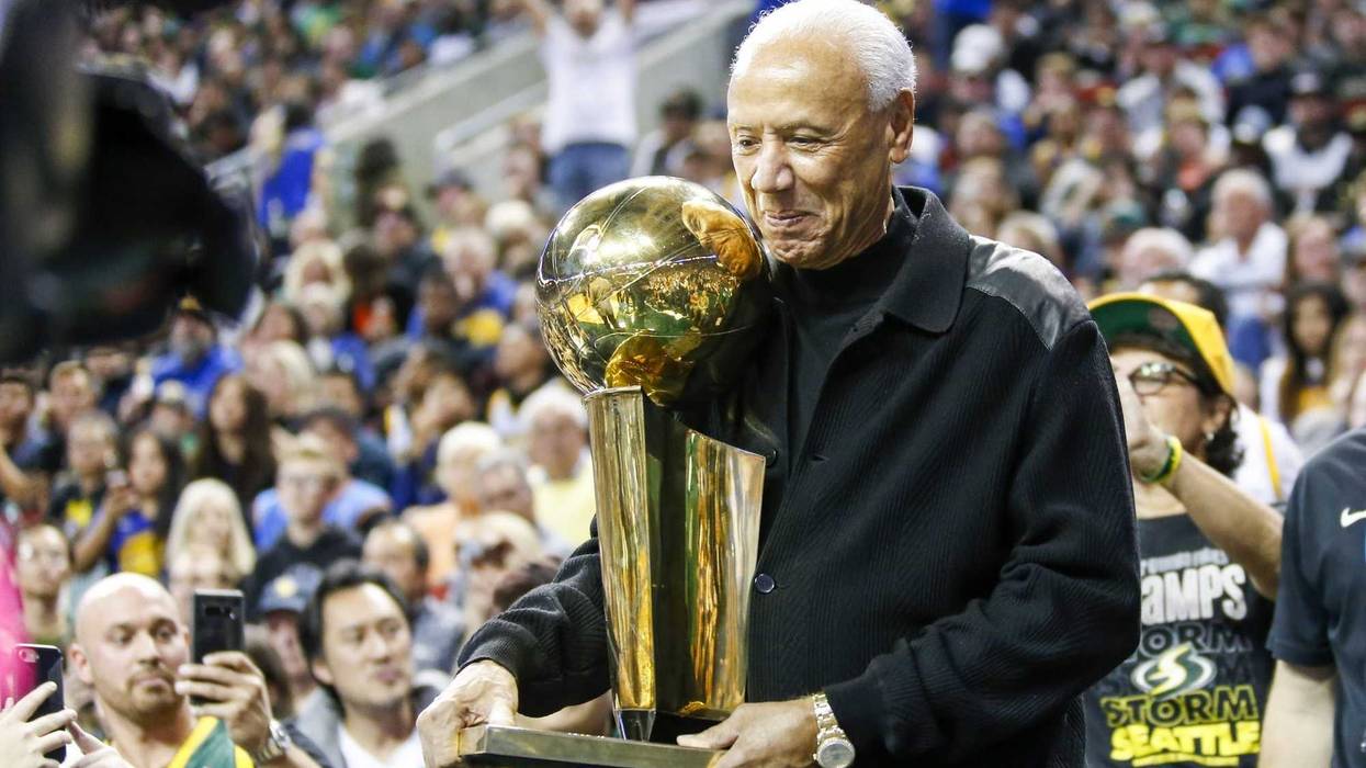 Oct 5, 2018; Seattle, WA, USA; Former Seattle Supersonics head coach Lenny Wilkens holds the 1979 championship trophy during a third quarter timeout of a game between the Sacramento Kings and Golden State Warriors at KeyArena.