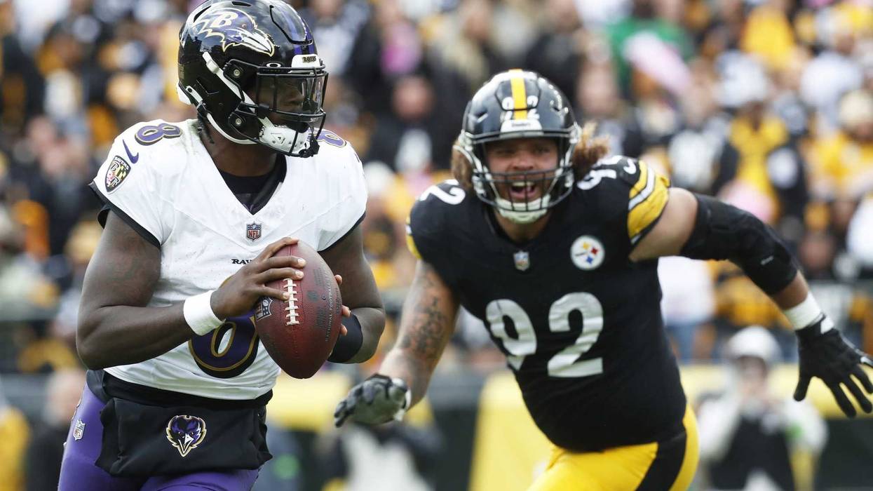Oct 8, 2023; Pittsburgh, Pennsylvania, USA; Baltimore Ravens quarterback Lamar Jackson (8) scrambles with the ball against the Pittsburgh Steelers during the fourth quarter at Acrisure Stadium.