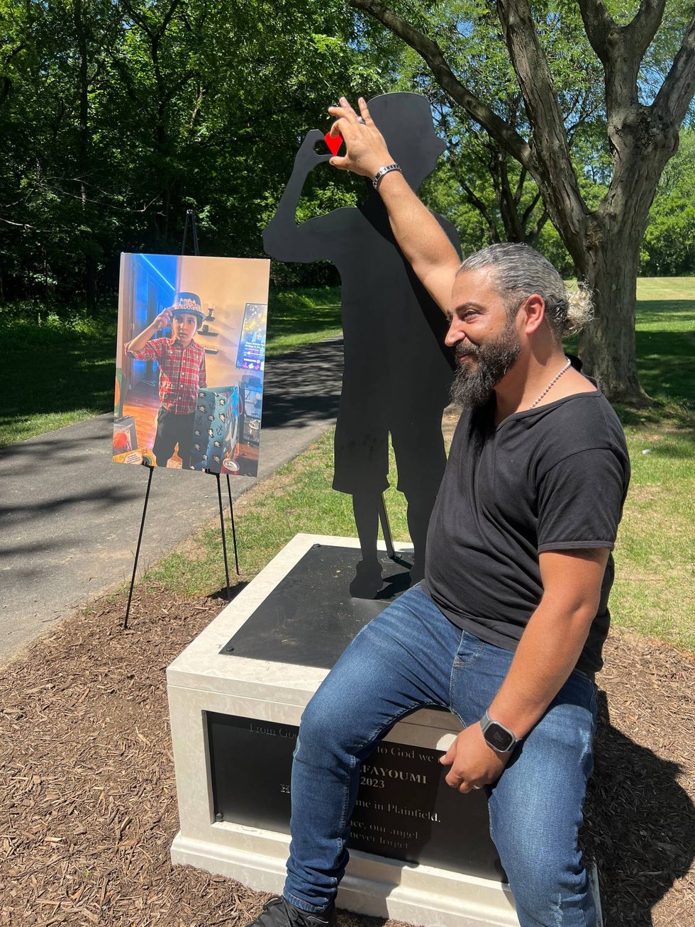 Odai al-Fayoume and a shadow-like silhouette of his slain son