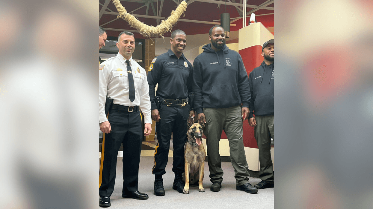 Officer Adrian Nunez-Santos with his new K-9 partner, Narco. The fully trained K-9 was sponsored by Philadelphia Eagle Fletcher Cox (background, center).