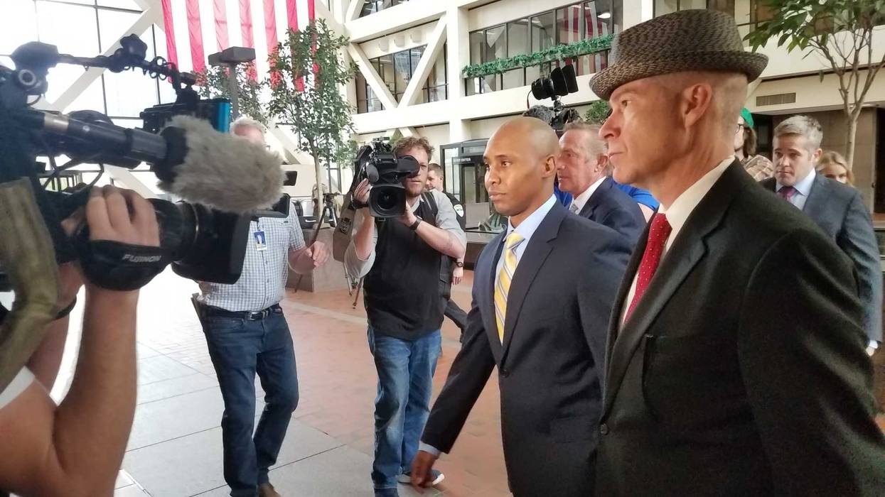 Officer Mohammed Noor (left) arrives with his attorney