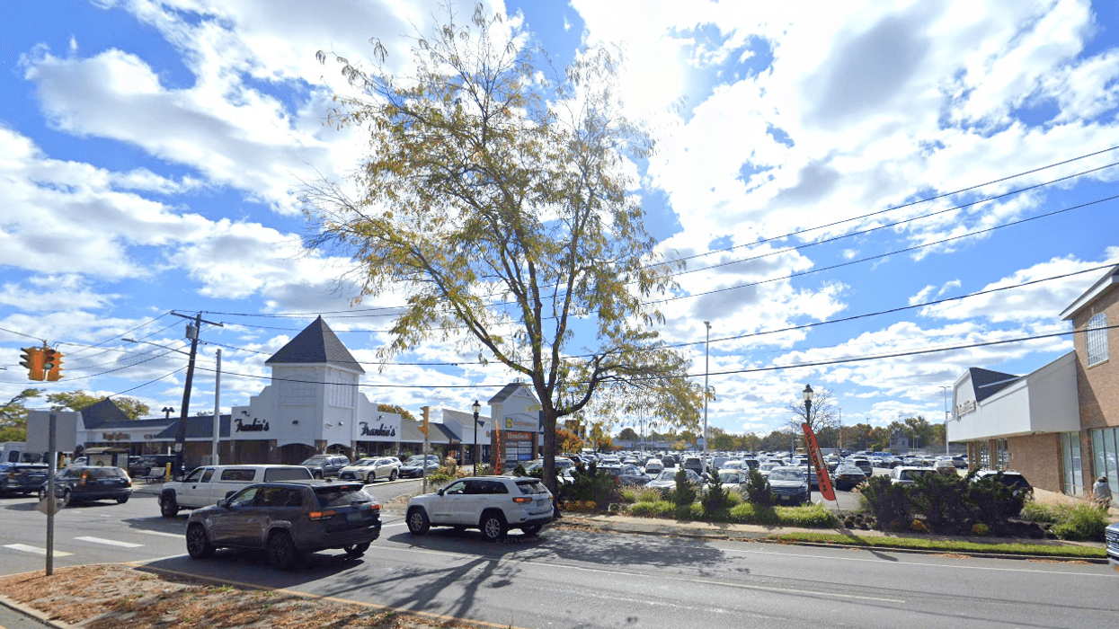 Officers found a 70-year-old man's body in the rear parking lot of Merrick Commons Thursday night.