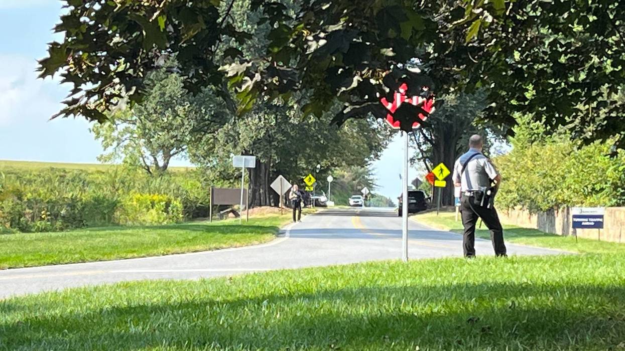 Officers looking down Conservatory Road from Longwood Road in Chester County during the search for Danelo Cavalcante.