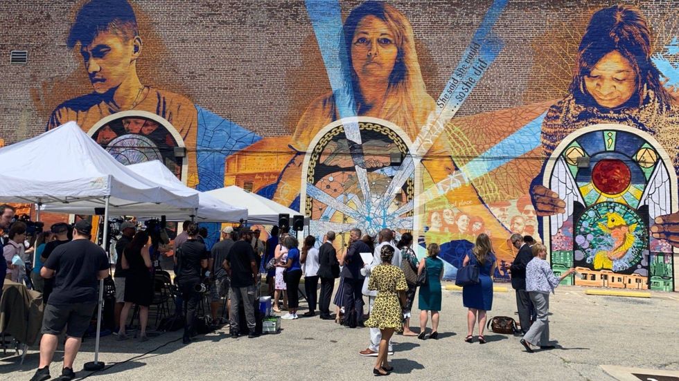Officials gather for the formal announcement at a mural dedicated to behavioral health at 57th and Chestnut streets in West Philadelphia.