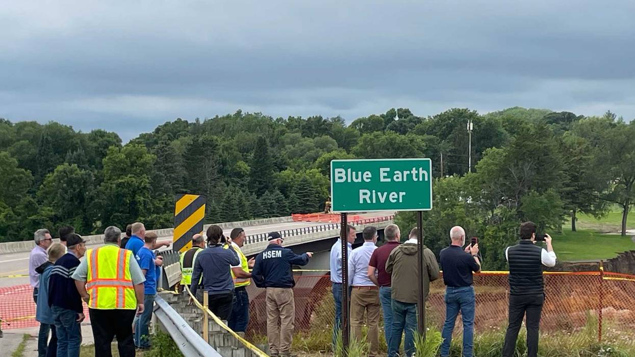Officials including Governor Tim Walz examine the flooding damage on the Blue Earth River in southern Minnesota Tuesday.