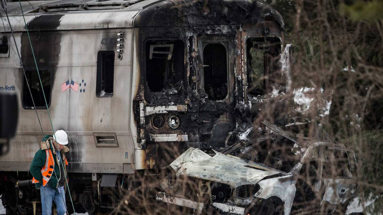 Officials inspect a Metro-North train crash with a sport utility vehicle on Feb. 4, 2015 in Valhalla, New York