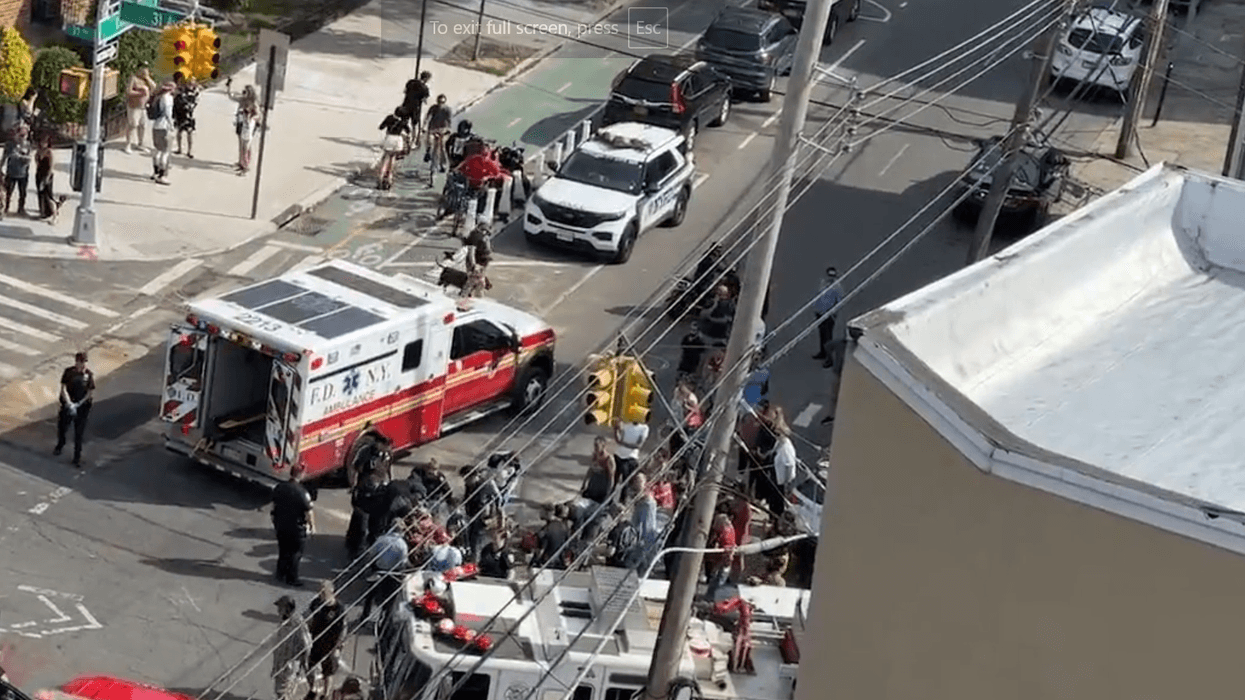 Officials respond to a scene in Astoria on Wednesday after a cyclist was struck by a vehicle fleeing police.