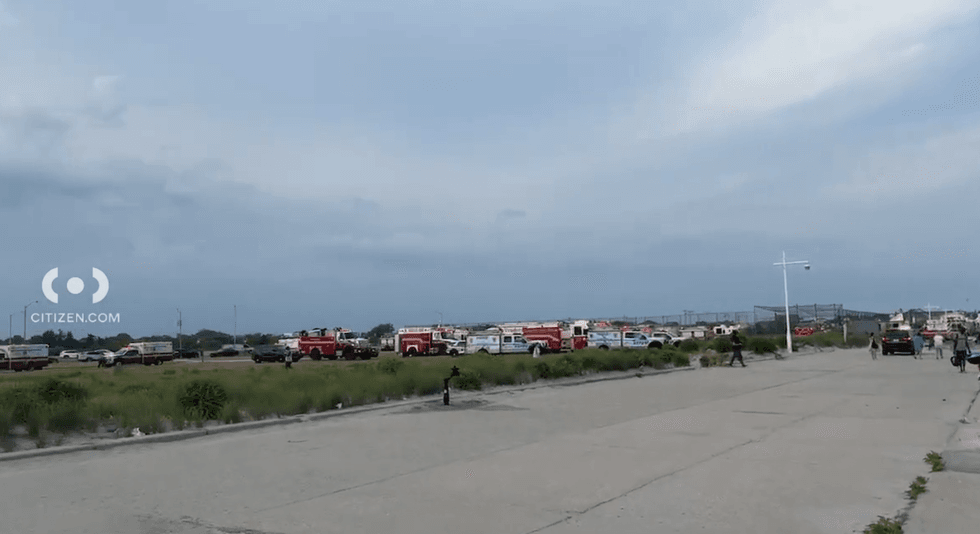 Officials respond to help in the search for two missing teen swimmers at Jacob Riis Park in Queens on Friday.