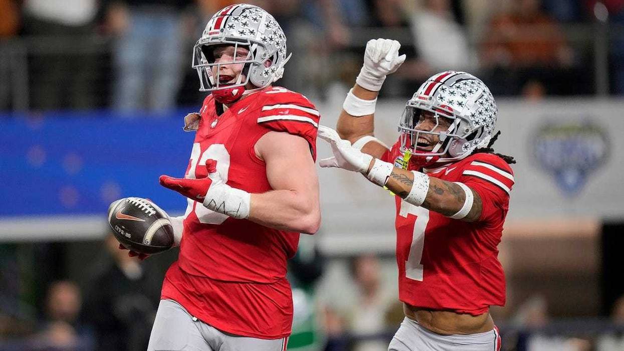 Ohio State Buckeyes defensive end Jack Sawyer (33) celebrates his touchdown return with Ohio State Buckeyes cornerback Jordan Hancock (7) against Texas Longhorns in the fourth quarter of the Cotton Bowl Classic during the College Football Playoff semifinal game at AT&T Stadium in Arlington, Texas on January, 10, 2025.