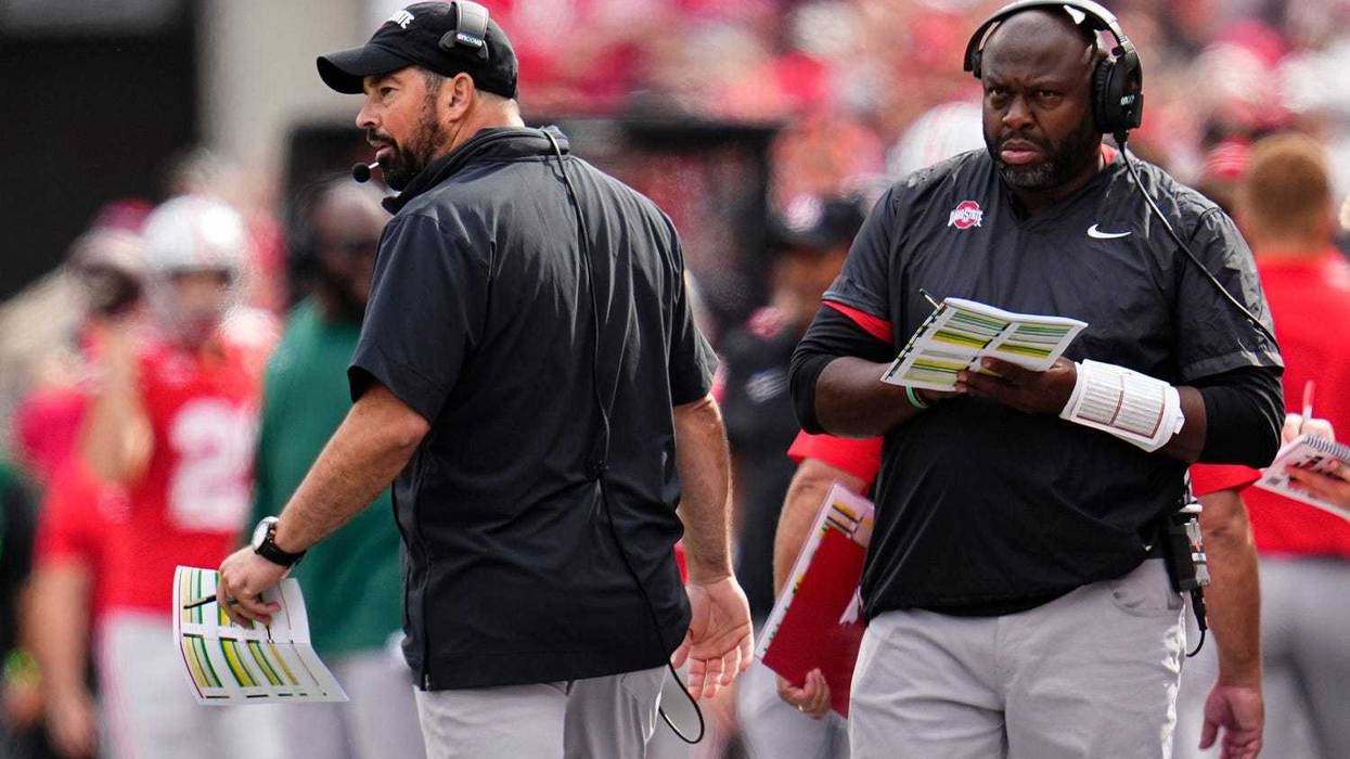 Ohio State Buckeyes head coach Ryan Day and running backs coach Tony Alford watch from the sideline during the NCAA football game against the Western Kentucky Hilltoppers at Ohio Stadium.