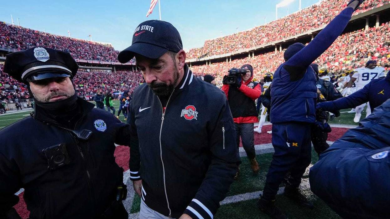 Ohio State Buckeyes head coach Ryan Day leaves the field shaking hands with Michigan Wolverines head coach Sherrone Moore, right, following the NCAA football game at Ohio Stadium in Columbus on Saturday, Nov. 30, 2024. Michigan won 13-10.