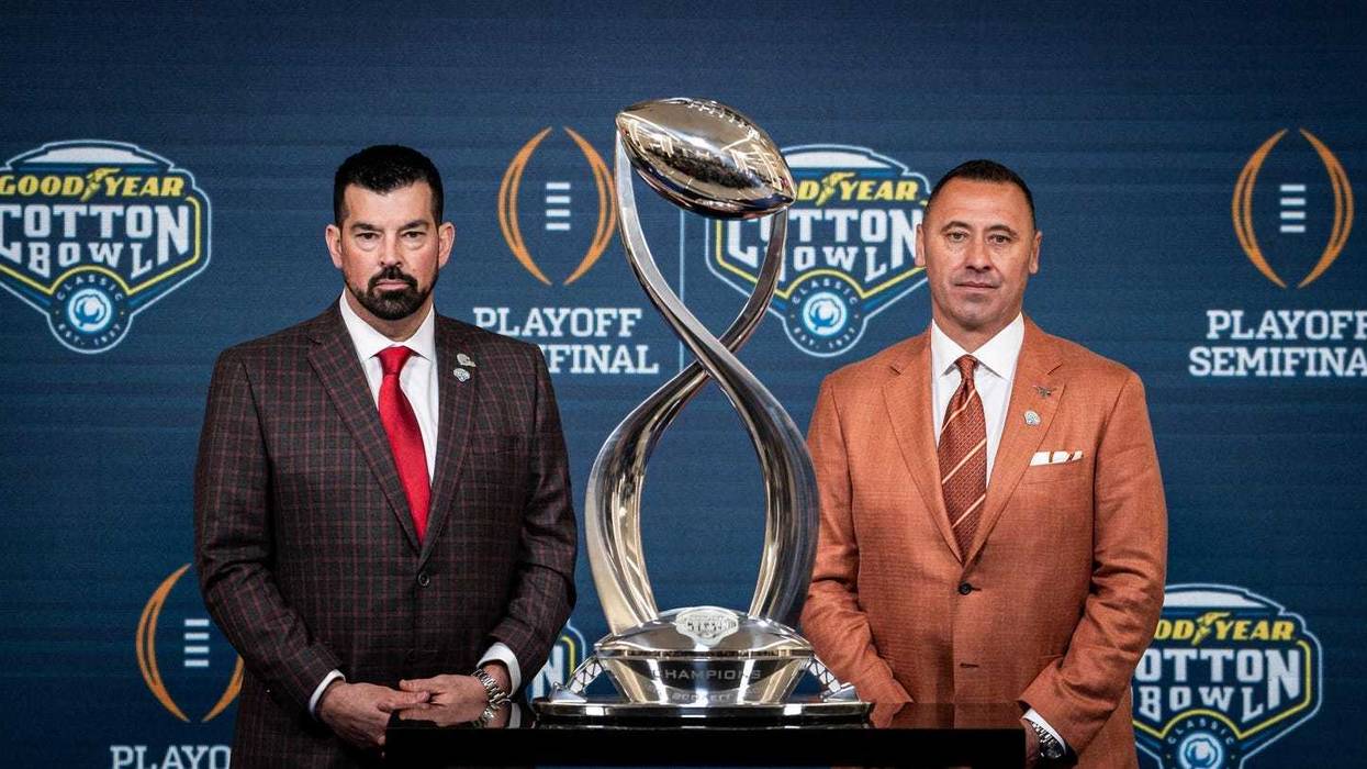 Ohio State Buckeyes Head Coach Ryan Day, left, and Texas Longhorns Head Coach Steve Sarkisian stand next to the trophy for a photo following the Coaches' Press Conference at AT&T Stadium, Jan. 9, 2024. Both coaches answered questions from the media during the conference, and will face each other in the Cotton Bowl College Football Playoff semi-final game on Friday.