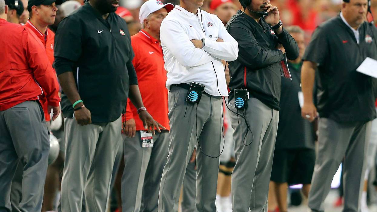 Ohio State Buckeyes head coach Urban Meyer (center) watches the game from the sidelines with assistant coach Ryan Day (right) and assistant coach Tony Alford (left) during the third quarter against the Ohio State Buckeyes at Ohio Stadium.