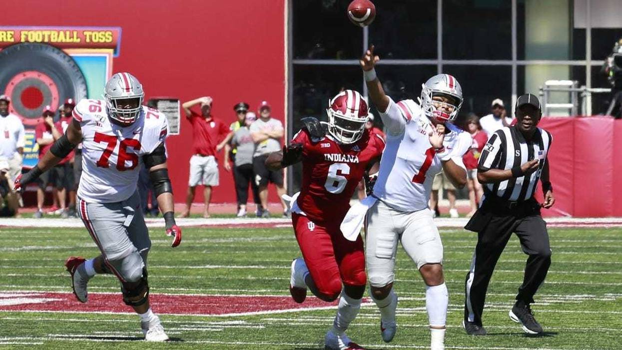 Ohio State Buckeyes quarterback Justin Fields (1) throws a pass against the Indiana Hoosiers during the second quarter at Memorial Stadium .