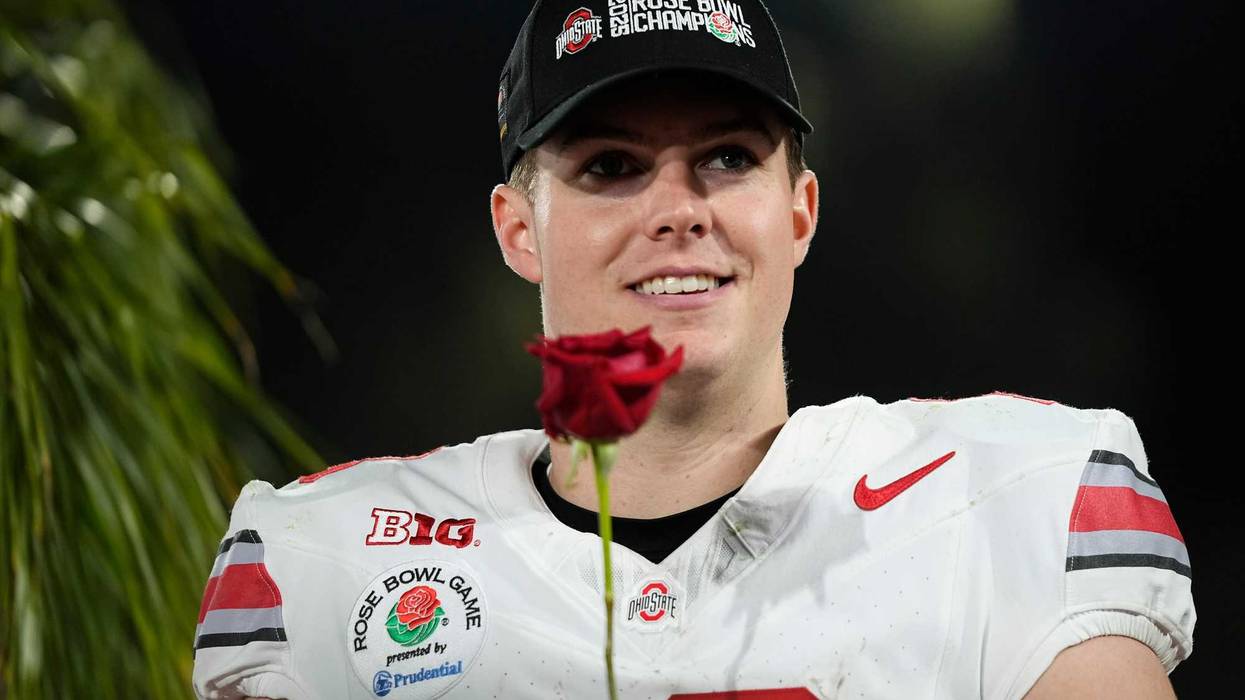 Ohio State Buckeyes quarterback Will Howard (18) holds a rose following the College Football Playoff quarterfinal against the Oregon Ducks at the Rose Bowl in Pasadena, Calif. on Jan. 1, 2025. Ohio State won 41-21.