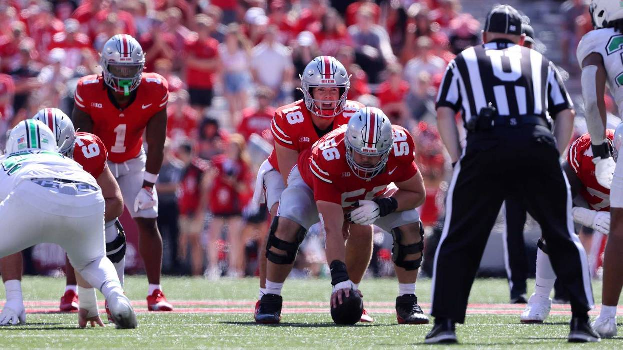 Ohio State Buckeyes quarterback Will Howard (18) lines up under Ohio State Buckeyes offensive lineman Seth McLaughlin (56) during the third quarter against the Marshall Thundering Herd at Ohio Stadium.