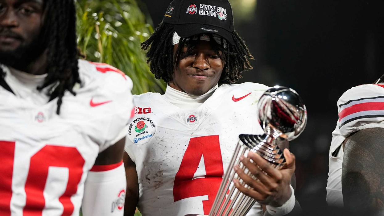 Ohio State Buckeyes wide receiver Jeremiah Smith (4) holds the Leishman Trophy following the 41-21 win over the Oregon Ducks in the College Football Playoff quarterfinal at the Rose Bowl in Pasadena, Calif. on Jan. 1, 2025.