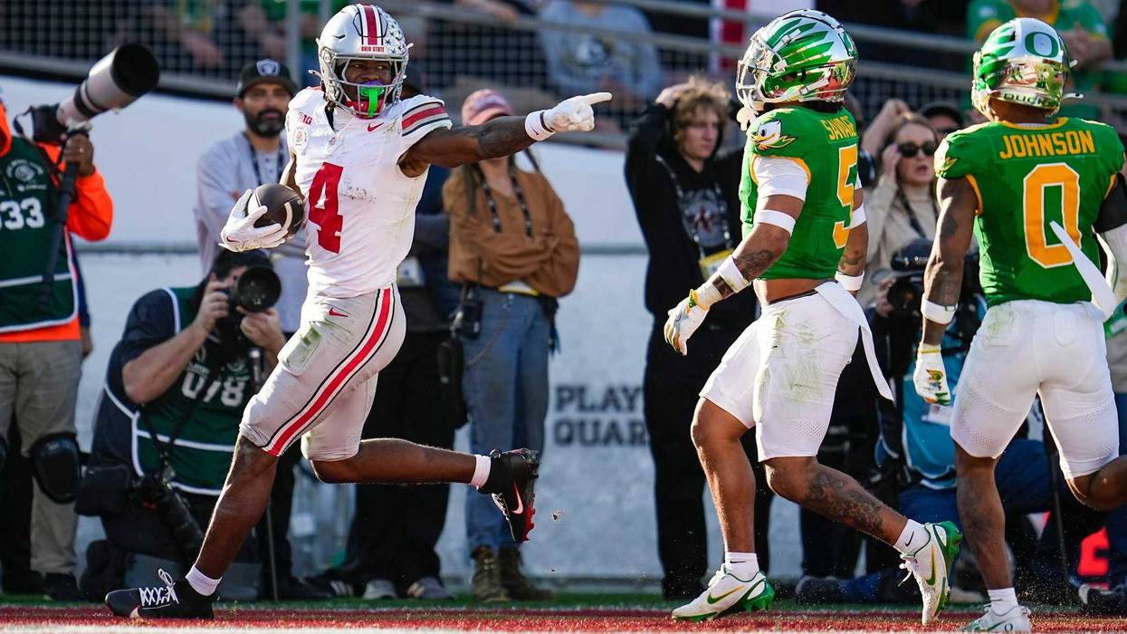 Ohio State Buckeyes wide receiver Jeremiah Smith (4) scores a touchdown in front of Oregon Ducks defensive back Kobe Savage (5) and defensive back Tysheem Johnson (0) during the first half of the College Football Playoff quarterfinal at the Rose Bowl in Pasadena, Calif. on Jan. 1, 2025.