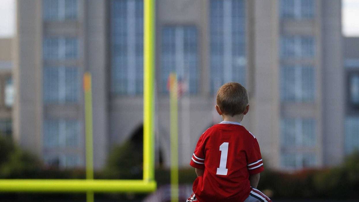 Ohio State fan Owen Nelms, 3, of Indianapolis, sits atop his dad, Brandon, before a NCAA Division I football game between the Indiana Hoosiers and the Ohio State Buckeyes on Saturday, September 14, 2019 at Memorial Stadium in Bloomington, Indiana.