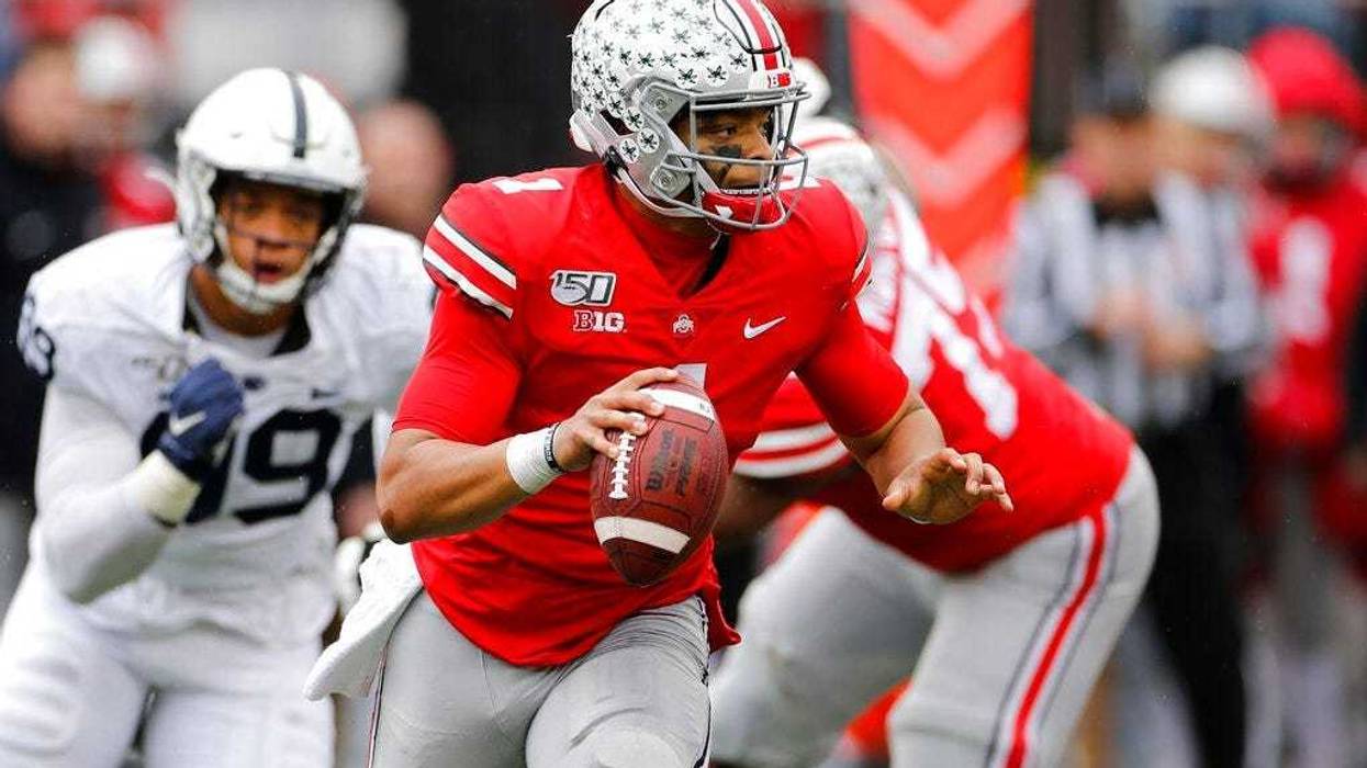Ohio State quarterback Justin Fields, right, looks for an open receiver as Penn State defensive lineman Yetur Gross-Matos chases him during the second half of an NCAA college football game Saturday, Nov. 23, 2019, in Columbus, Ohio. Ohio State beat Penn S