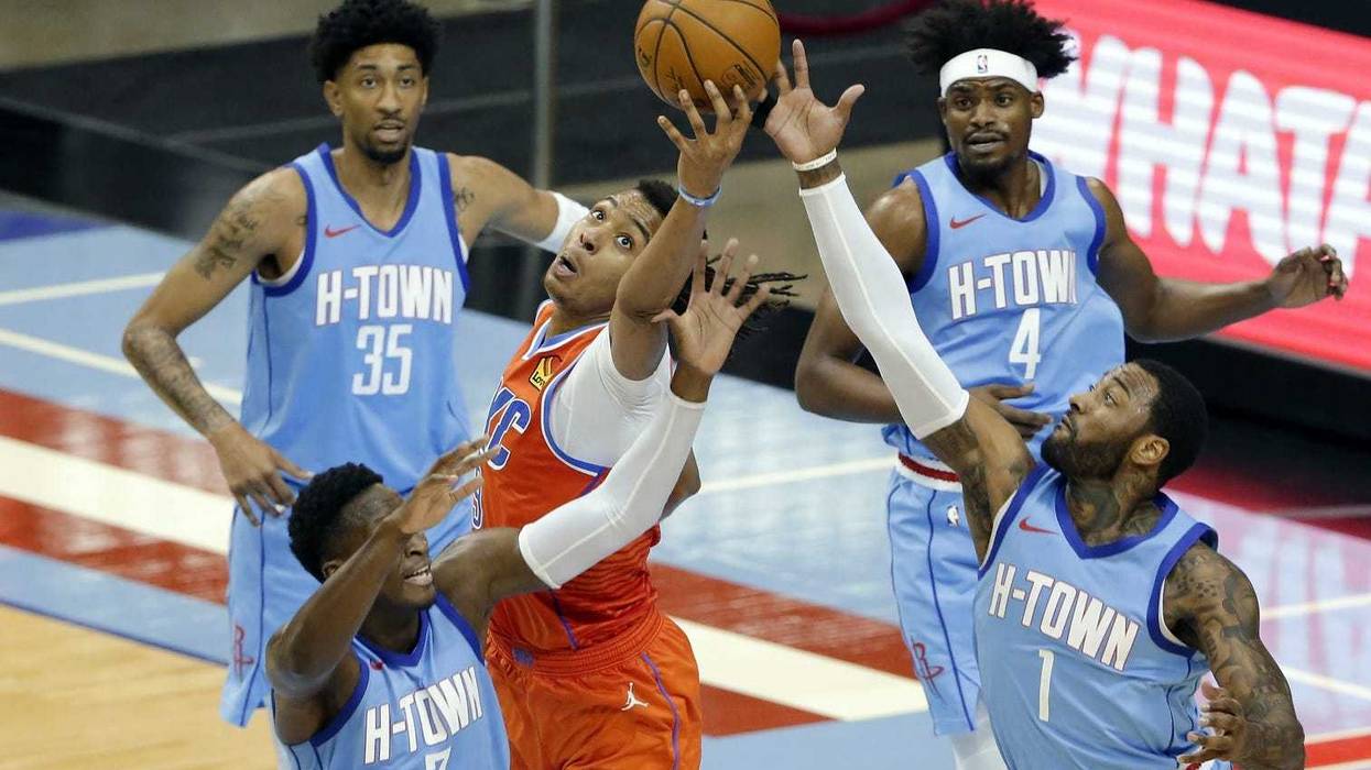 Oklahoma City Thunder center Moses Brown, middle, reaches for a rebound between, from left, Houston Rockets guard Victor Oladipo (7) center Christian Wood (35), forward Danuel House Jr. (4) and guard John Wall (1) during the second half of an NBA basketball game Sunday, March 21, 2021, in Houston.