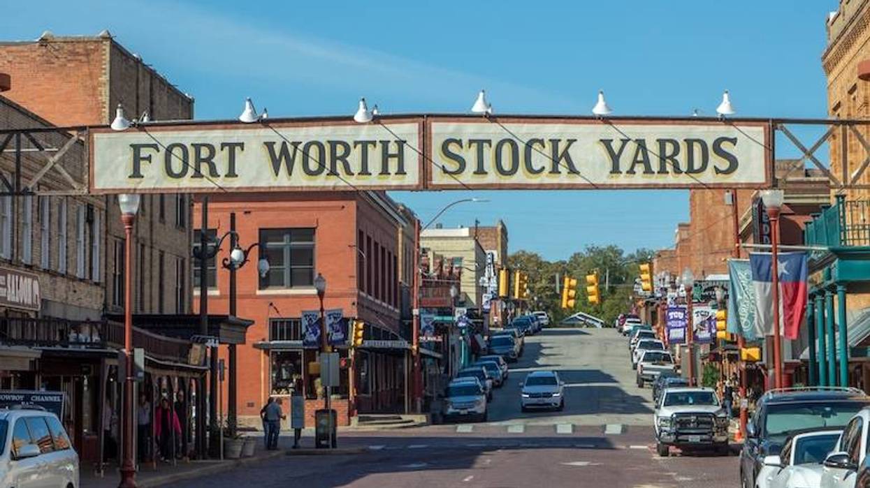Old brick buildings in Fort Worth at Stockyards, the former cattle market with historic entry signage