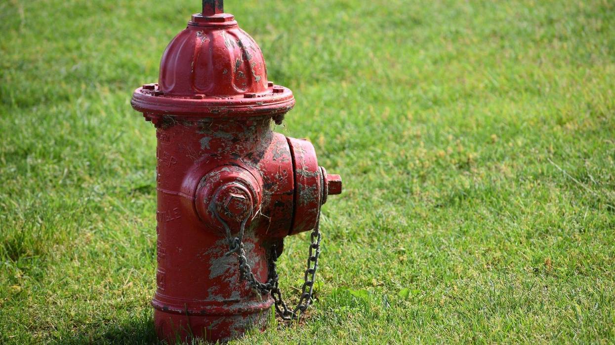 Old red fire hydrant in urban neighborhood