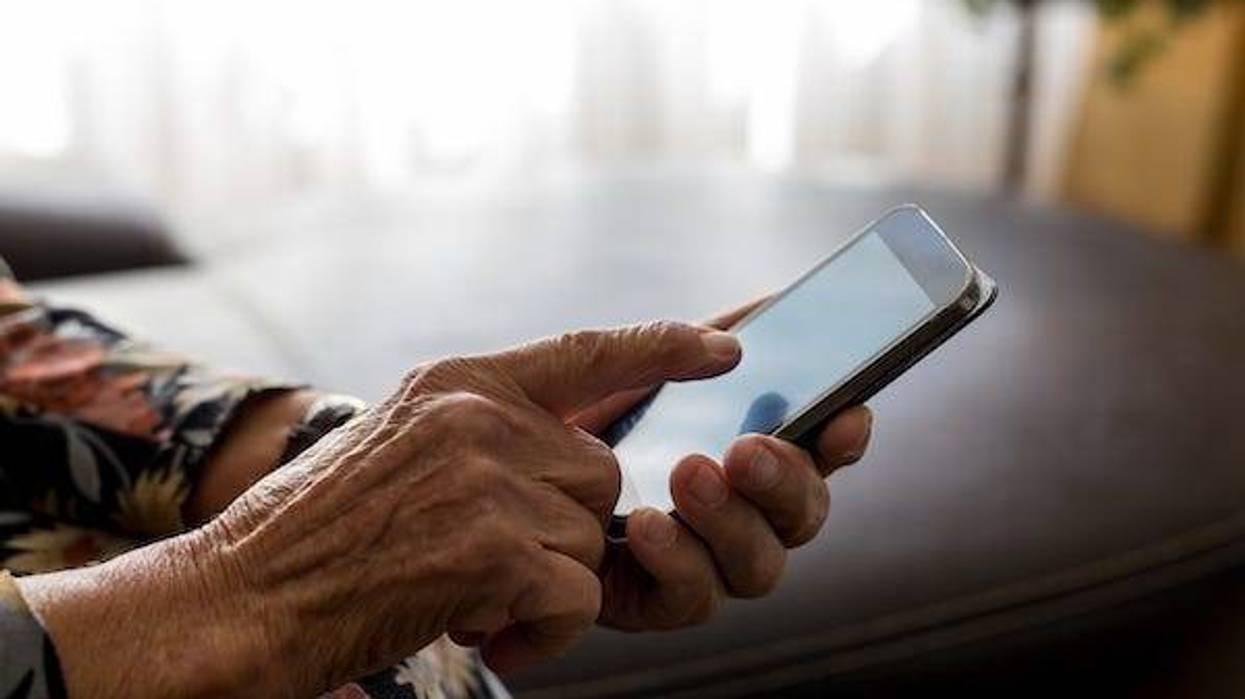 Old woman holding smartphone