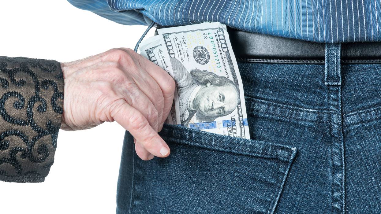 old woman putting money in someone's pocket