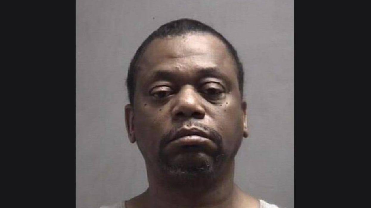 Older Black man frowning with black hair and black beard