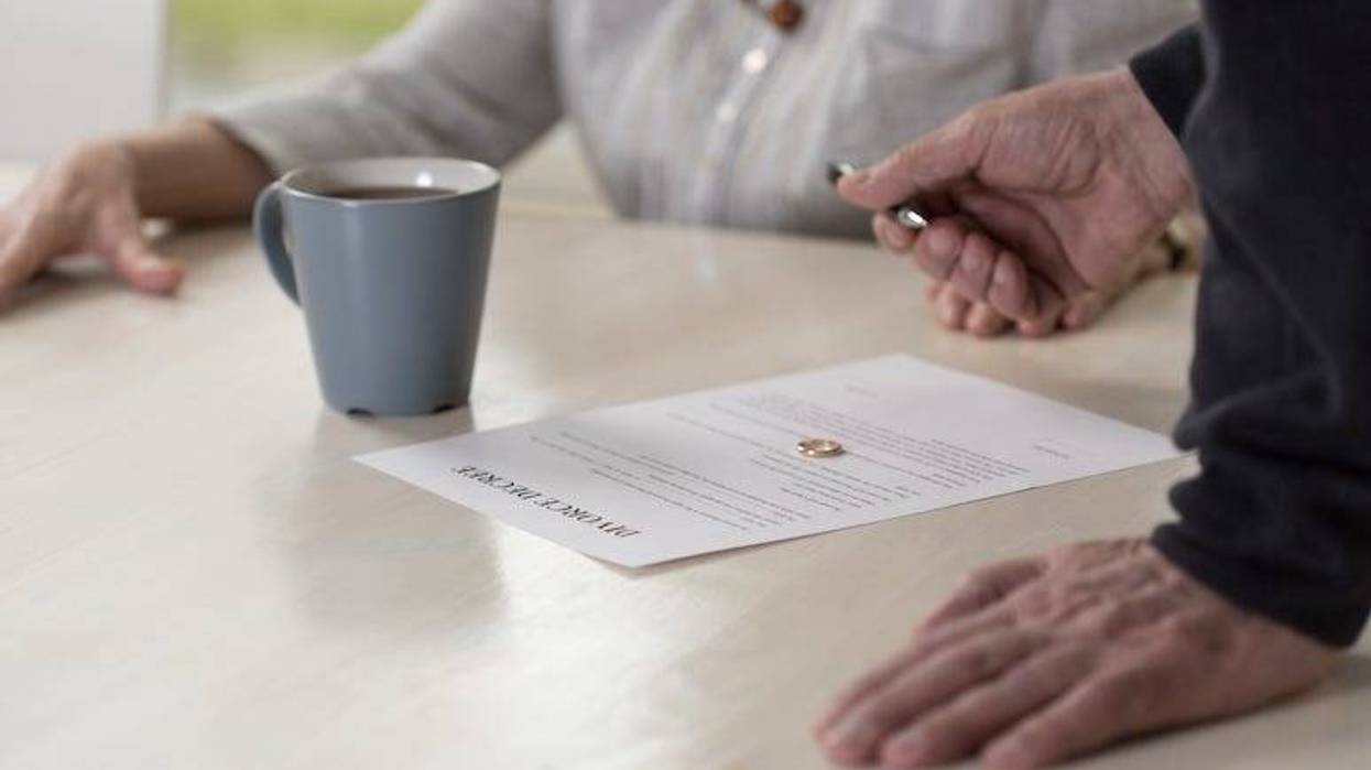 Older couple signing divorce papers