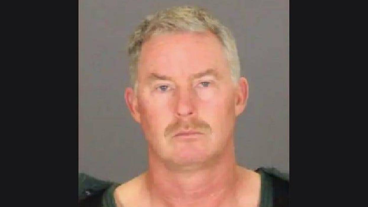 Older man frowning in mug shot