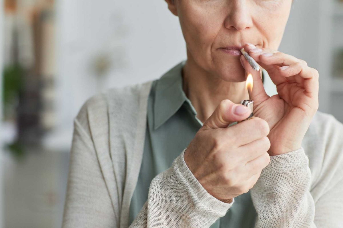 Older woman smoking marijuana.