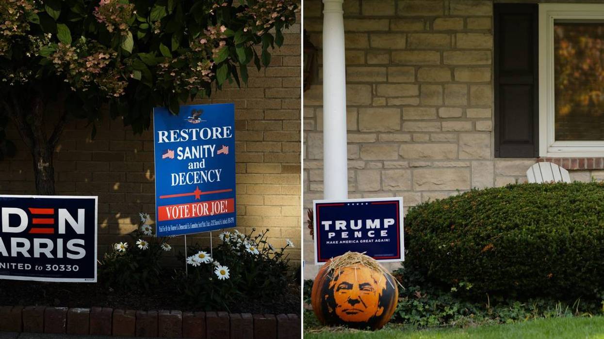 On the left, signs in support of Democratic presidential candidate and former vice president Joe Biden sit outside the Yoss Law Office on Friday, Oct. 9, 2020 in Woodsfield, Ohio.