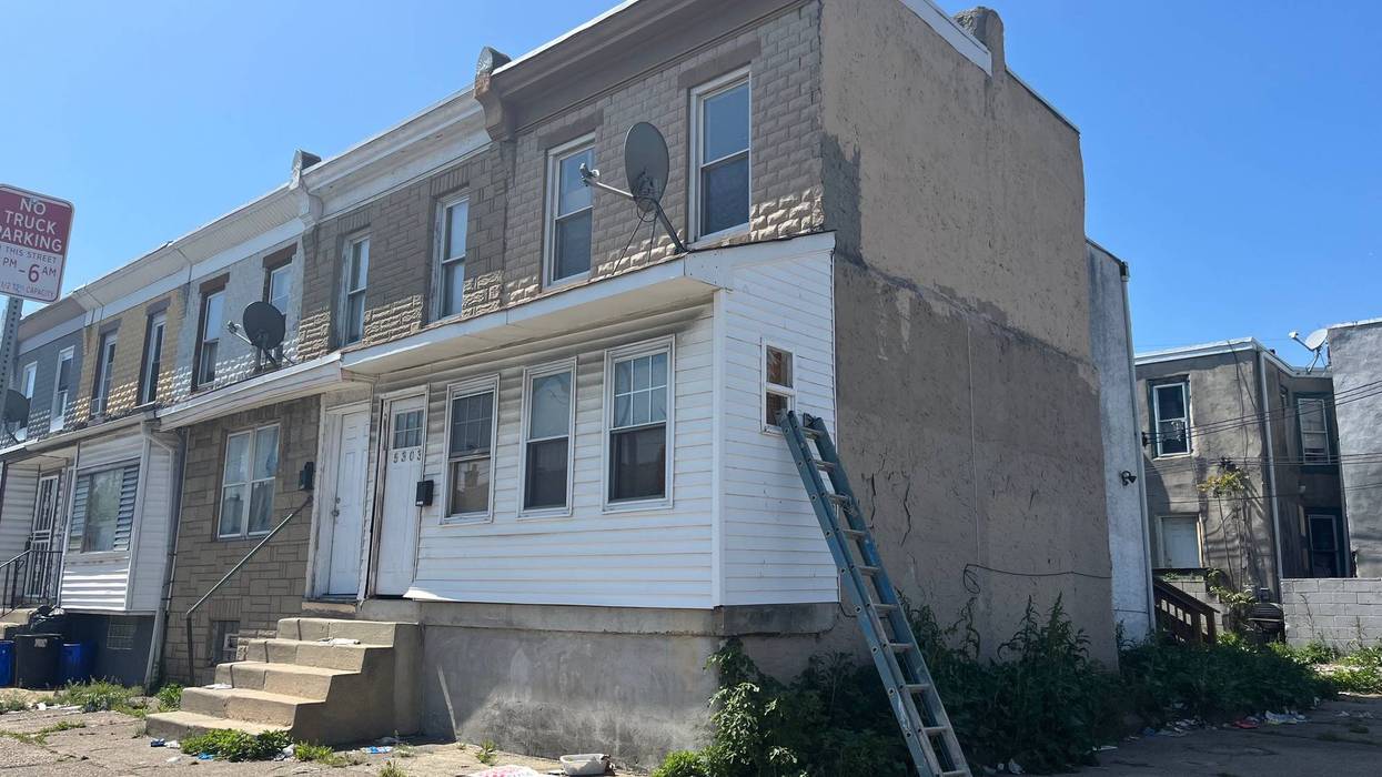 On the sidewalk next to the ladder leaning against this house, Philadelphia police found a 16-year-old boy who had been shot twice in the head.