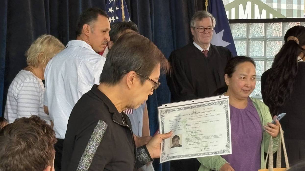 On the stage inside the International Bazaar on the fairgrounds where about two dozen new U.S citizens read the Pledge of Allegiance for the first time.