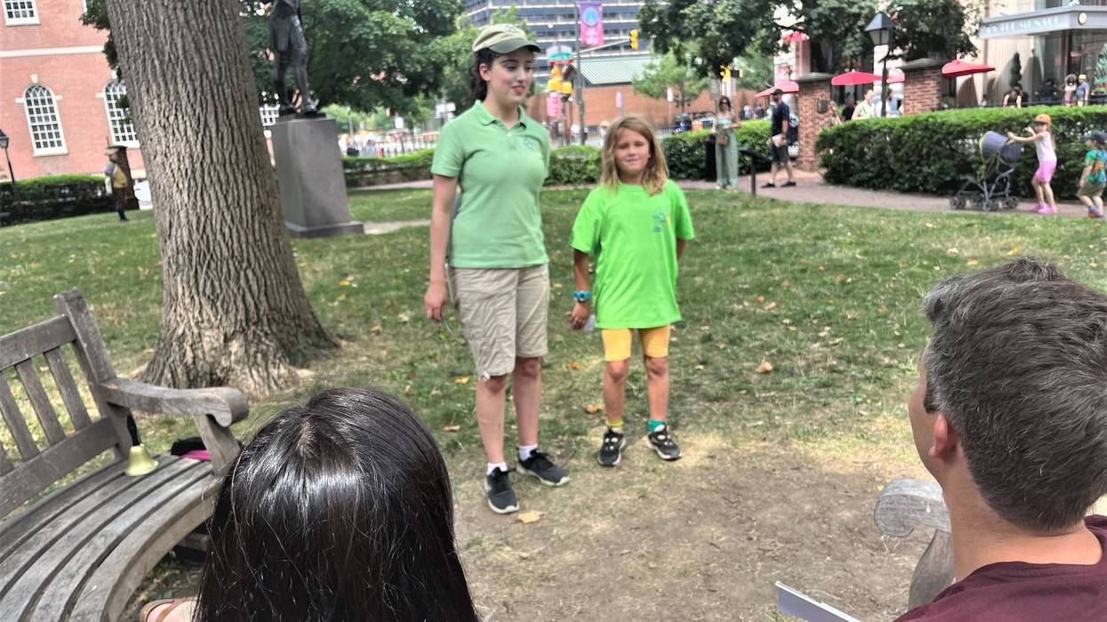 Once Upon a Nation storyteller Lucy Fletcher (left) watches as 9-year-old Franny tells seated visitors the story of Roger Arlener Young.