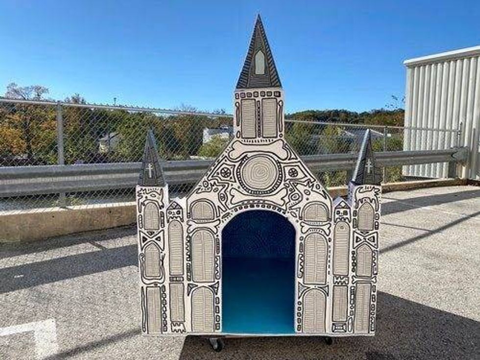 One of the dog houses up for auction was designed to look like a cathedral.