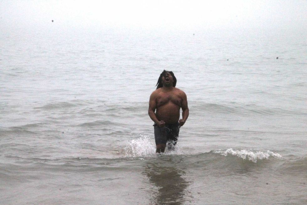 One of the last people into the water took a moment to celebrate the accomplishment.