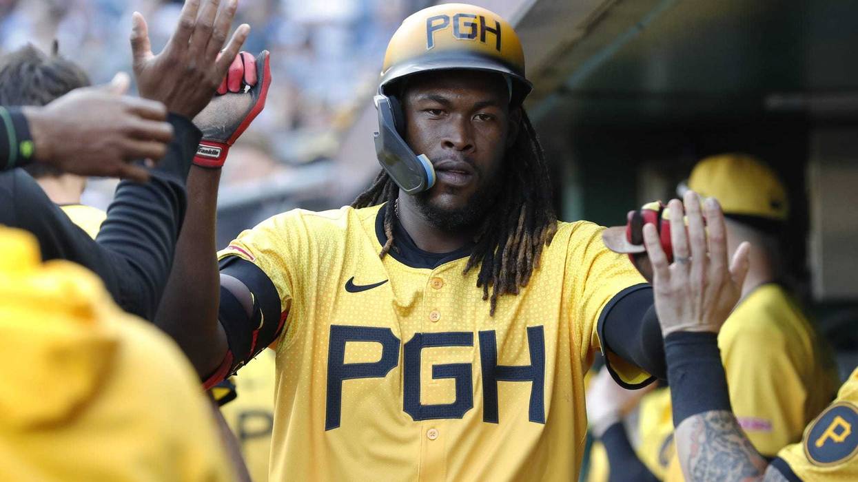 Oneil Cruz slapping hands in dugout