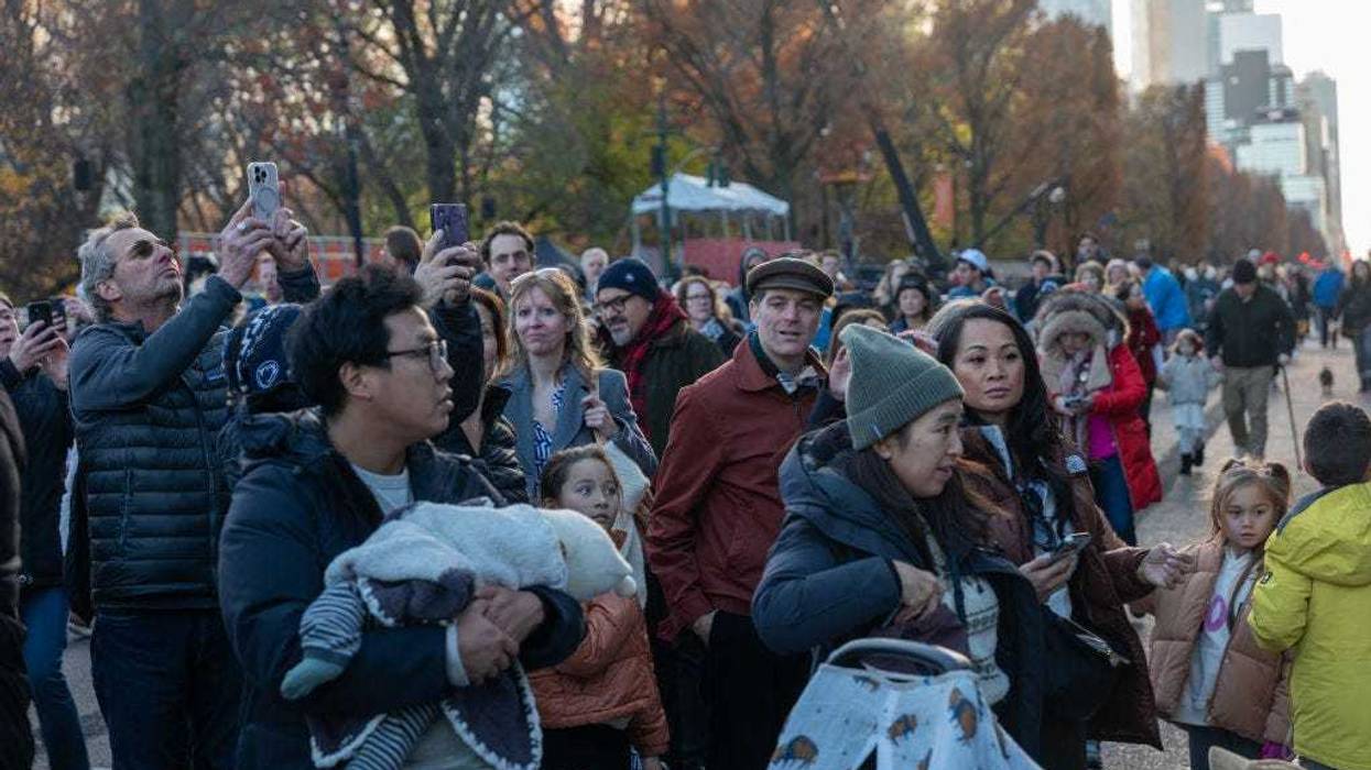 Onlookers watch as workers participate in the annual balloon inflation for the 2024 Macy's Thanksgiving Day Parade on Nov. 27, 2024 in New York City.