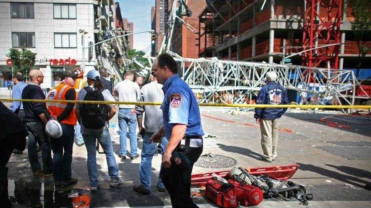 onstruction workers observe the scene of a crane collapse on Manhattan's Upper East Side at 91st Street and 1st Avenue May 30, 2008 in New York. The crane collapsed on top of an apartment building crashing into a penthouse apartment and falling to the gro