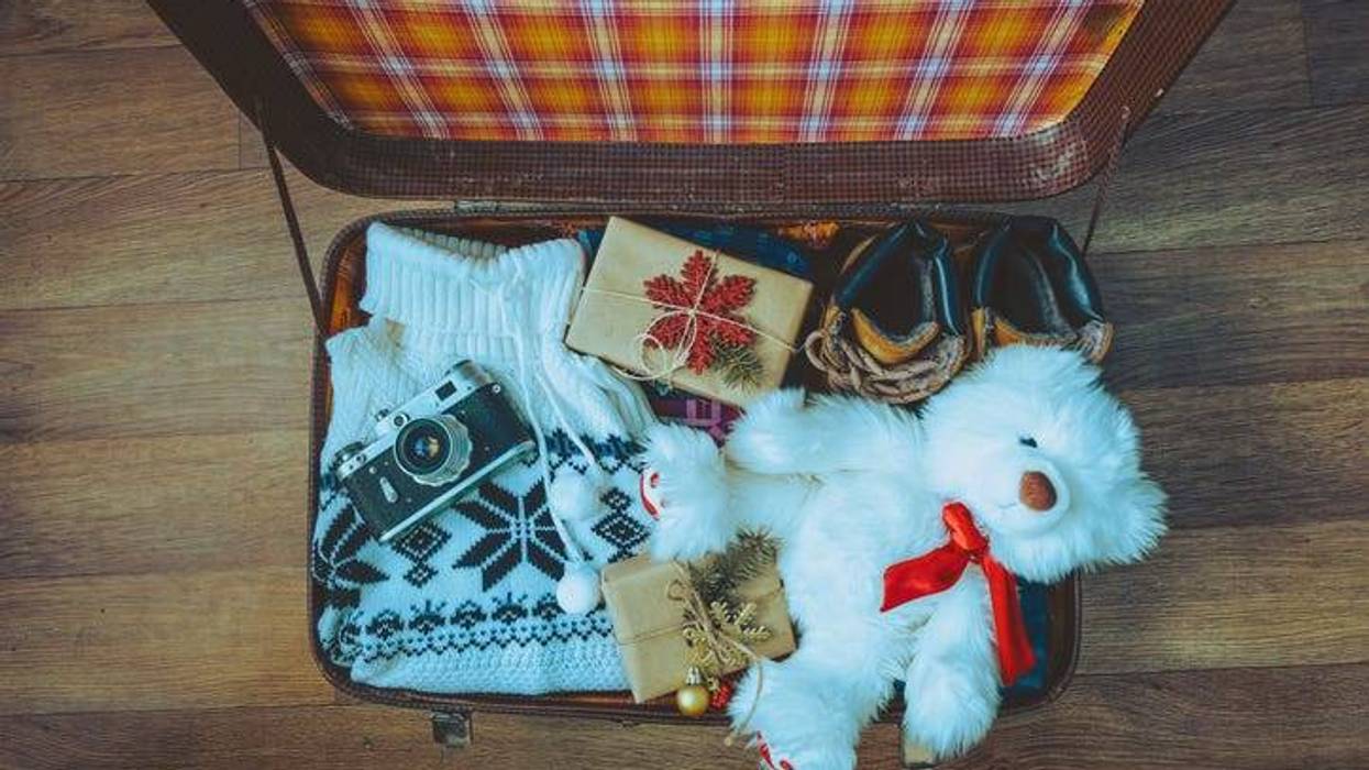 open suitcase with holiday gifts inside