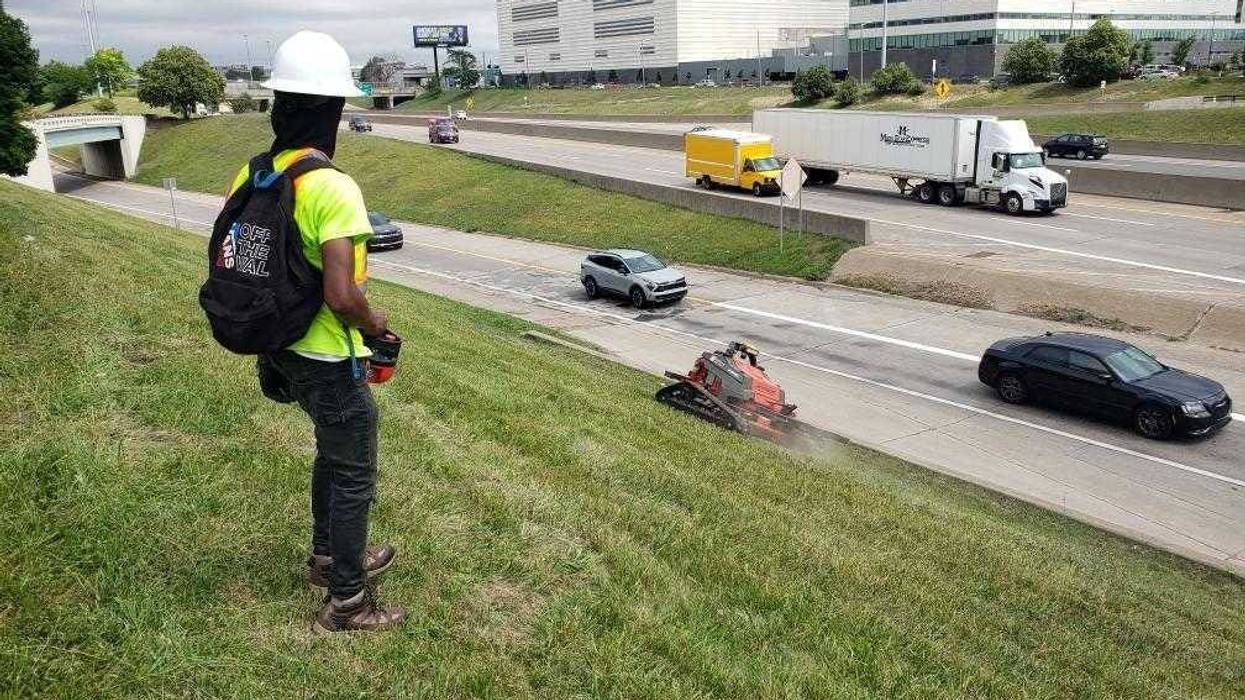 Operating a remote-controlled lawnmower in Detroit.
