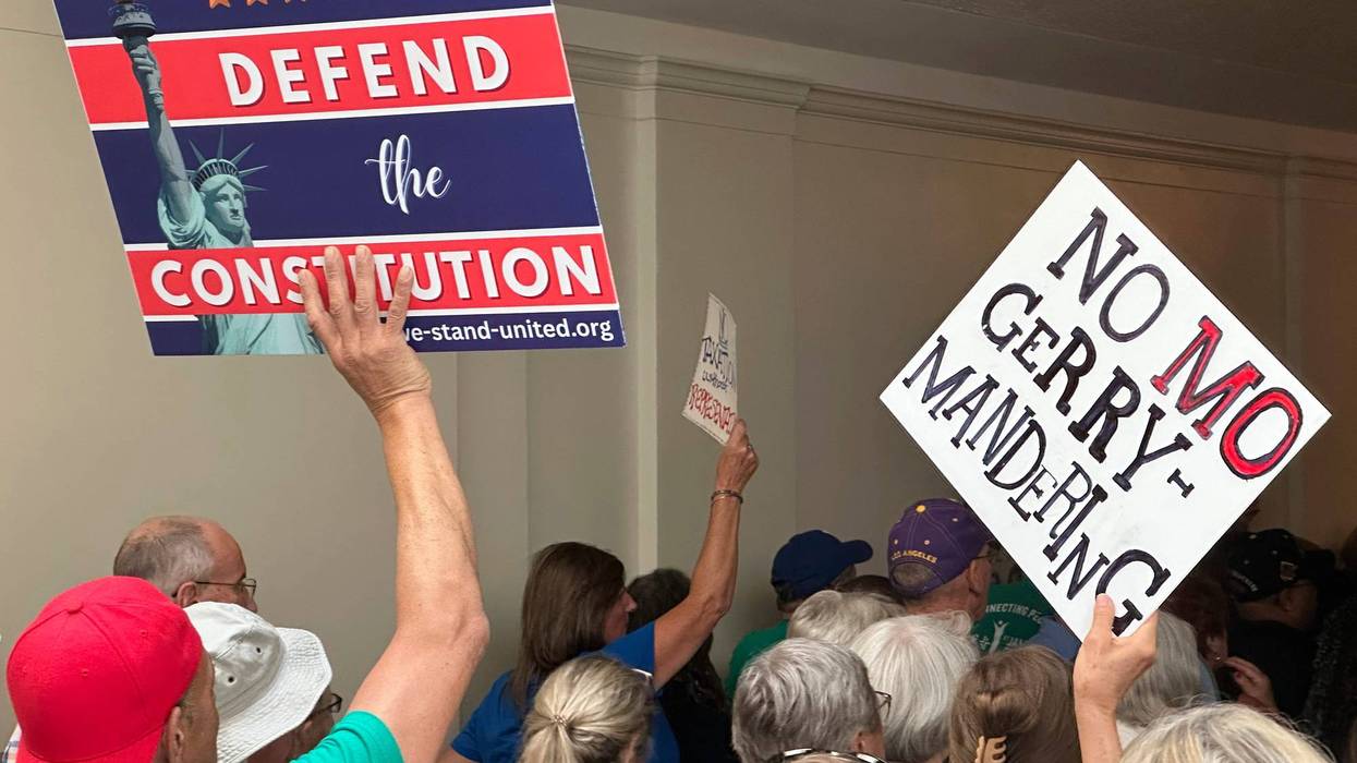 Opponents of a Republican plan to redraw Missouri's U.S. House districts march through a hallway outside the state Senate chamber in Jefferson City, Mo., Wednesday, Sept. 10, 2025.