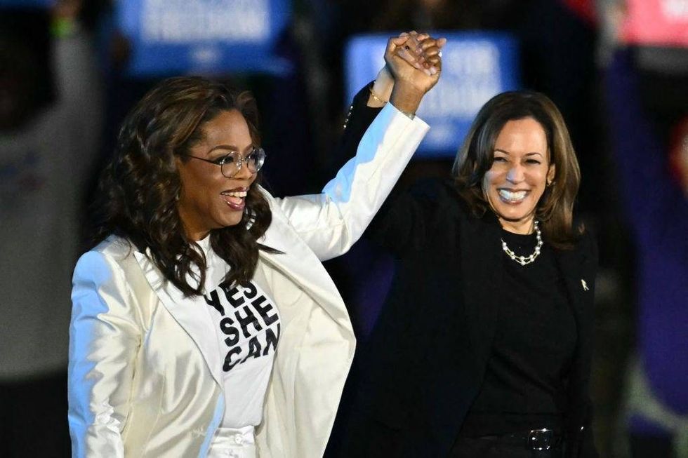 Oprah Winfrey holds up Kamala Harris