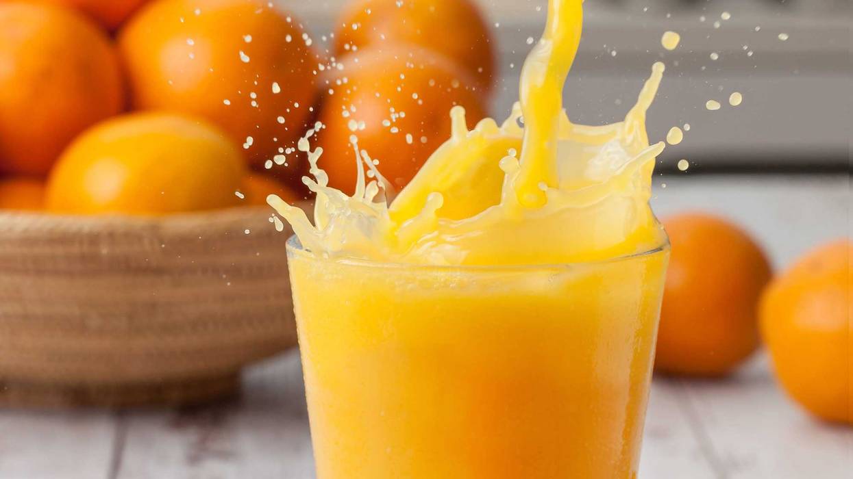 Orange juice poured into a glass.