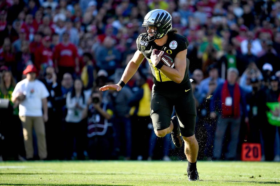 Oregon quarterback Justin Herbert keeps it himself