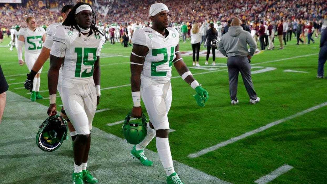 Oregon safety Jamal Hill (19) and linebacker Ge'mon Eaford leave the field after the team's NCAA college football game against Arizona State, Saturday, Nov. 23, 2019, in Tempe, Ariz. Arizona State won 31-28.