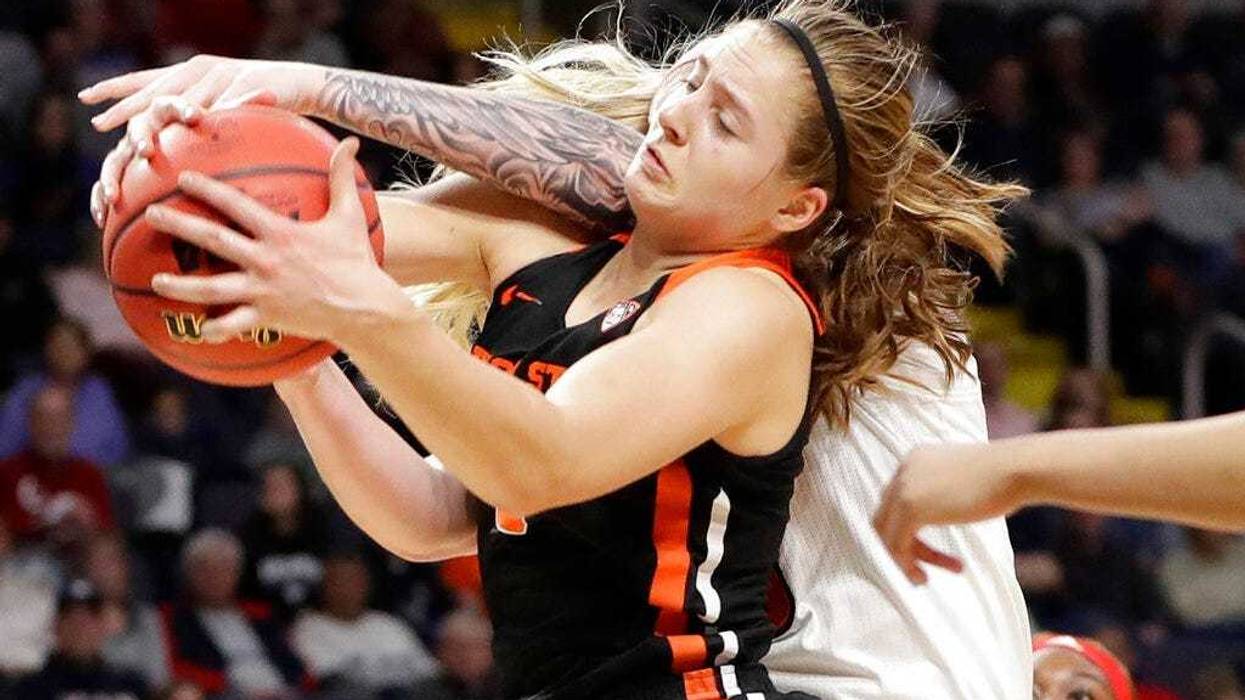 Oregon State guard Mikayla Pivec (0) battles for the ball with Louisville forward Sam Fuehring during the first half of a regional semifinal game in the NCAA women's college basketball tournament, Friday, March 29, 2019, in Albany, N.Y.